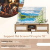 TV stand in oak finish supporting flat screen TVs up to 70", featuring fluted doors and open shelves for storage.