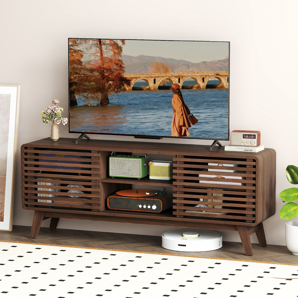 Walnut TV stand showcasing sliding doors and adjustable shelves, with a stylish mid-century design for versatile living.