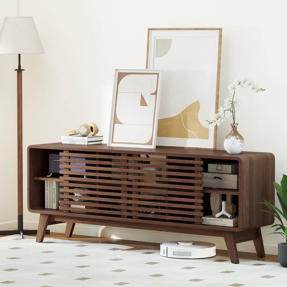 Close-up of the walnut TV stand's sliding doors and adjustable shelves, highlighting mid-century design and.