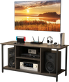 3-Tier gray TV stand with adjustable shelf, power outlet, and open storage for media supplies and audio speakers.