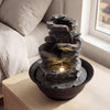 Tabletop water fountain with LED light, showcasing a serene water flow and a lightweight resin structure for easy.
