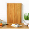 Extra large 24" teak wood cutting board with smooth finish, ideal for cutting, serving, and enhancing kitchen.