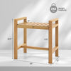 Teak wood shower bench with slat top, dual side handles, and water-resistant finish for bathroom storage and seating.