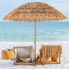 Thatched tiki umbrella with foldable stand, providing sun protection for beach relaxation and easy transport.