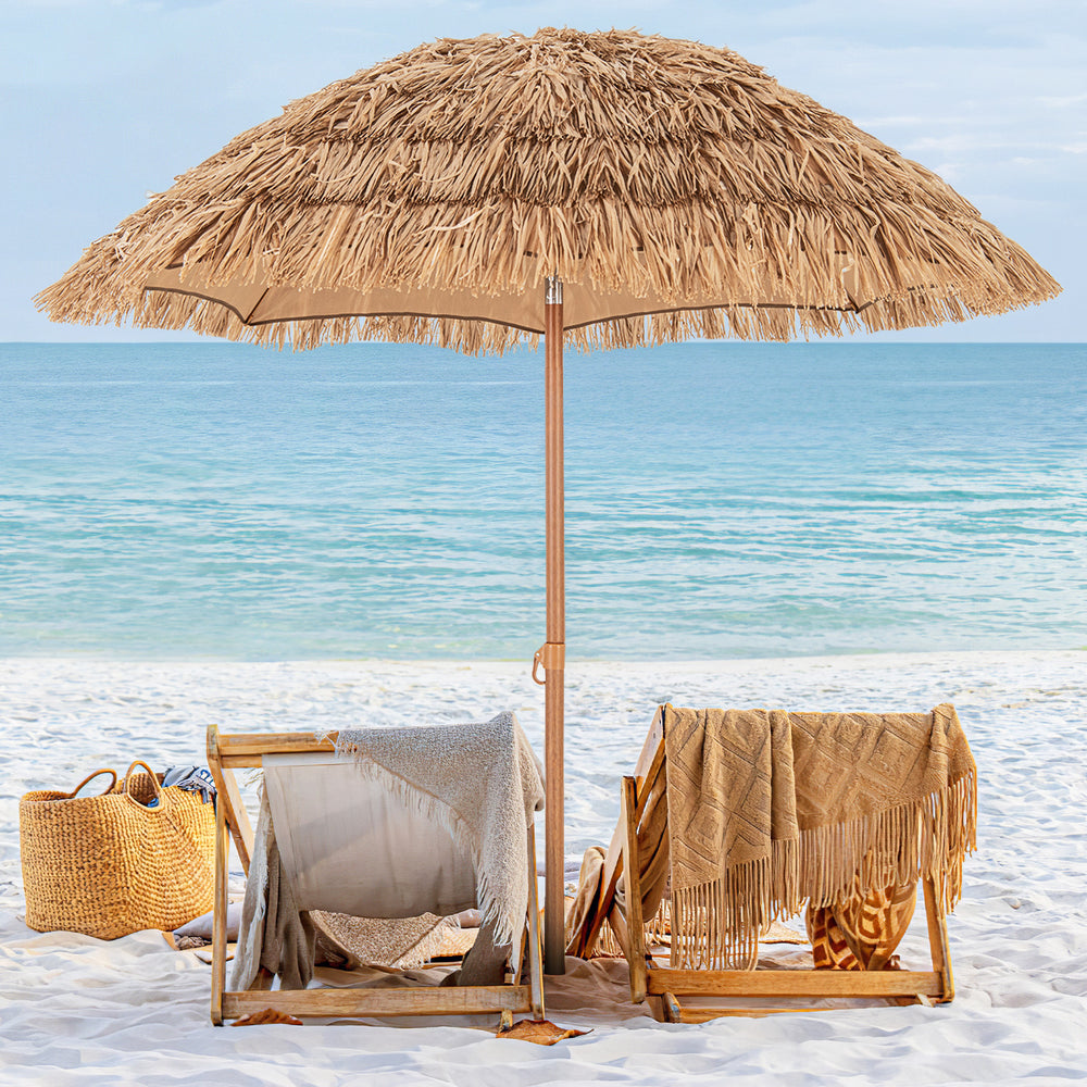 Thatched tiki umbrella with foldable stand, providing sun protection for beach relaxation and easy transport.