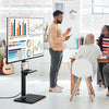 Tilt and height adjustable floor TV stand for 32"-70" TVs, featuring a built-in power outlet and extra storage shelves.