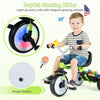 Toddler tricycle in green with glowing wheels, adjustable seat, and storage basket for safe, fun rides indoors and.