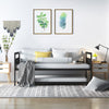 Twin metal daybed with trundle, featuring lockable wheels and a sleek industrial design, perfect for living rooms or.