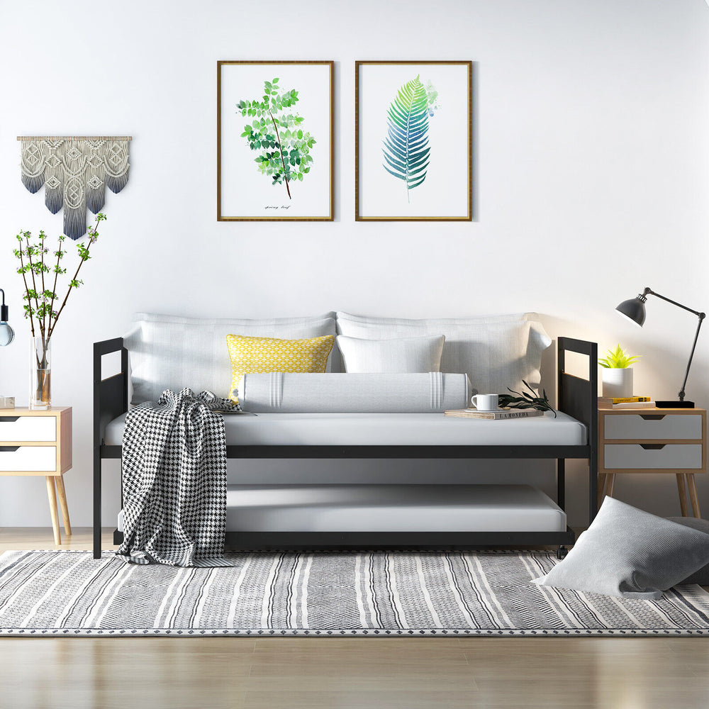 Twin metal daybed with trundle, featuring lockable wheels and a sleek industrial design, perfect for living rooms or.