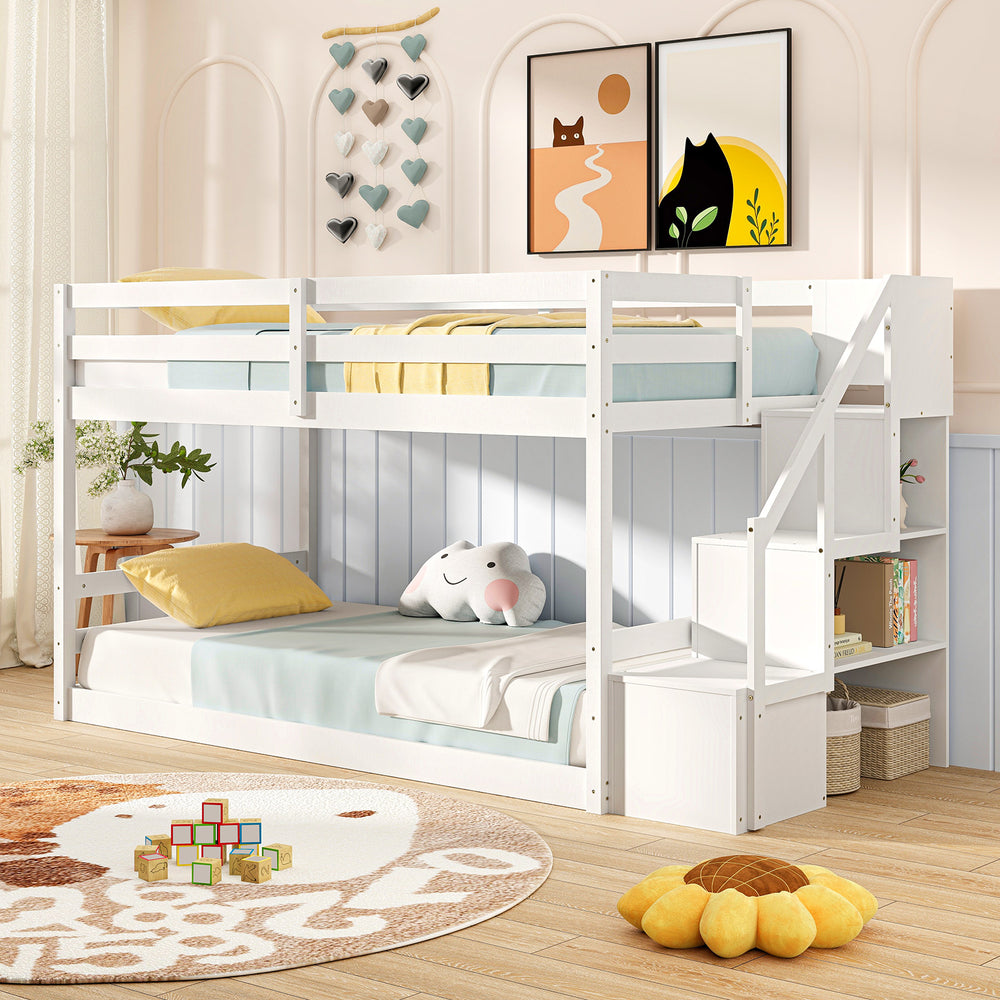 Twin over twin low bunk bed in white with storage stairs and open compartments for organized kids' room.