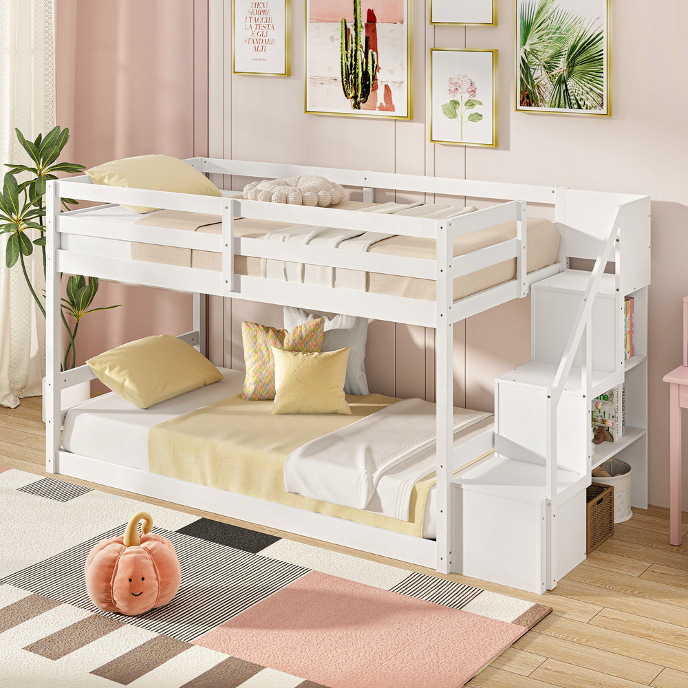 Twin over twin low bunk bed in white featuring a solid wood frame and spacious under-bed area for additional storage.