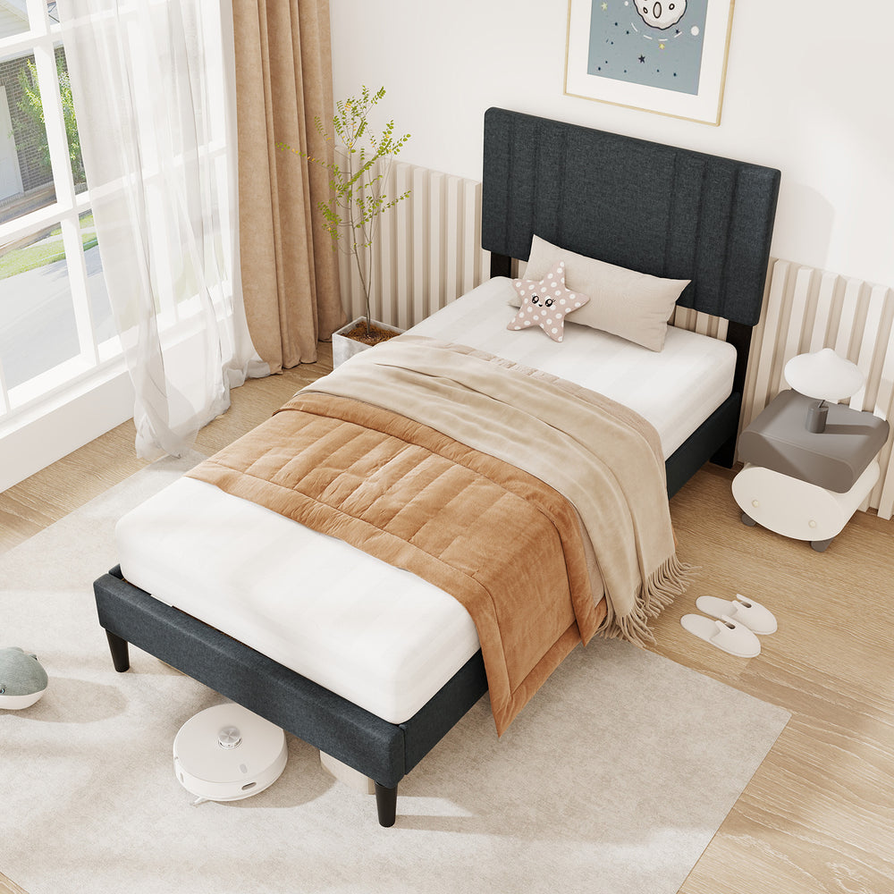 Twin size bed frame with vertical channel tufted headboard, faux linen fabric, and wooden slats for modern bedroom.