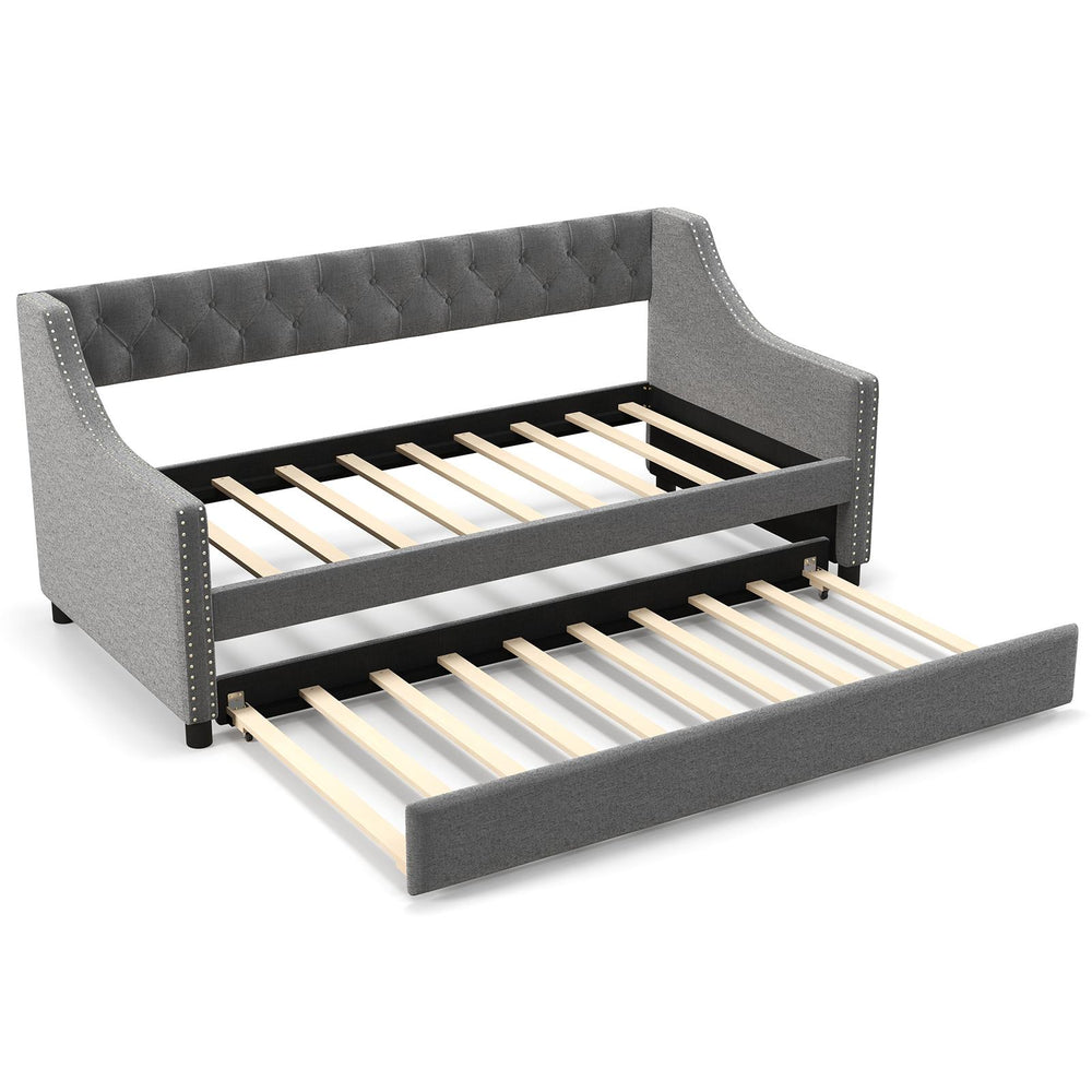Twin size gray daybed with trundle, featuring curved armrests and wooden frame for space-saving comfort and style.