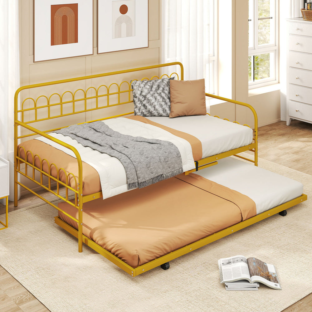 Twin size golden metal daybed with trundle and lockable wheels, perfect for accommodating overnight guests in any room.