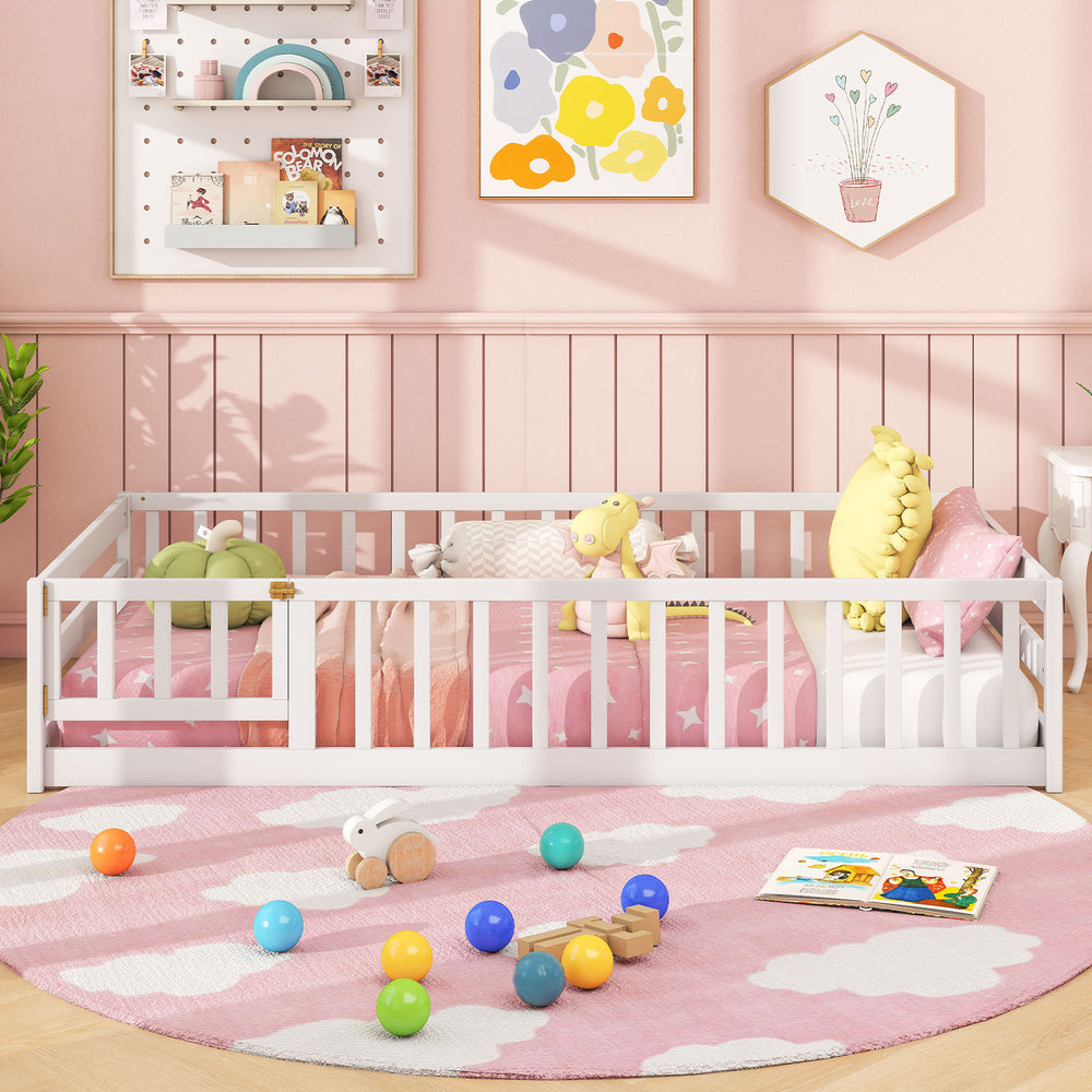 Twin size white Montessori floor bed with fence and door, designed for safety and easy access, perfect for kids' play.