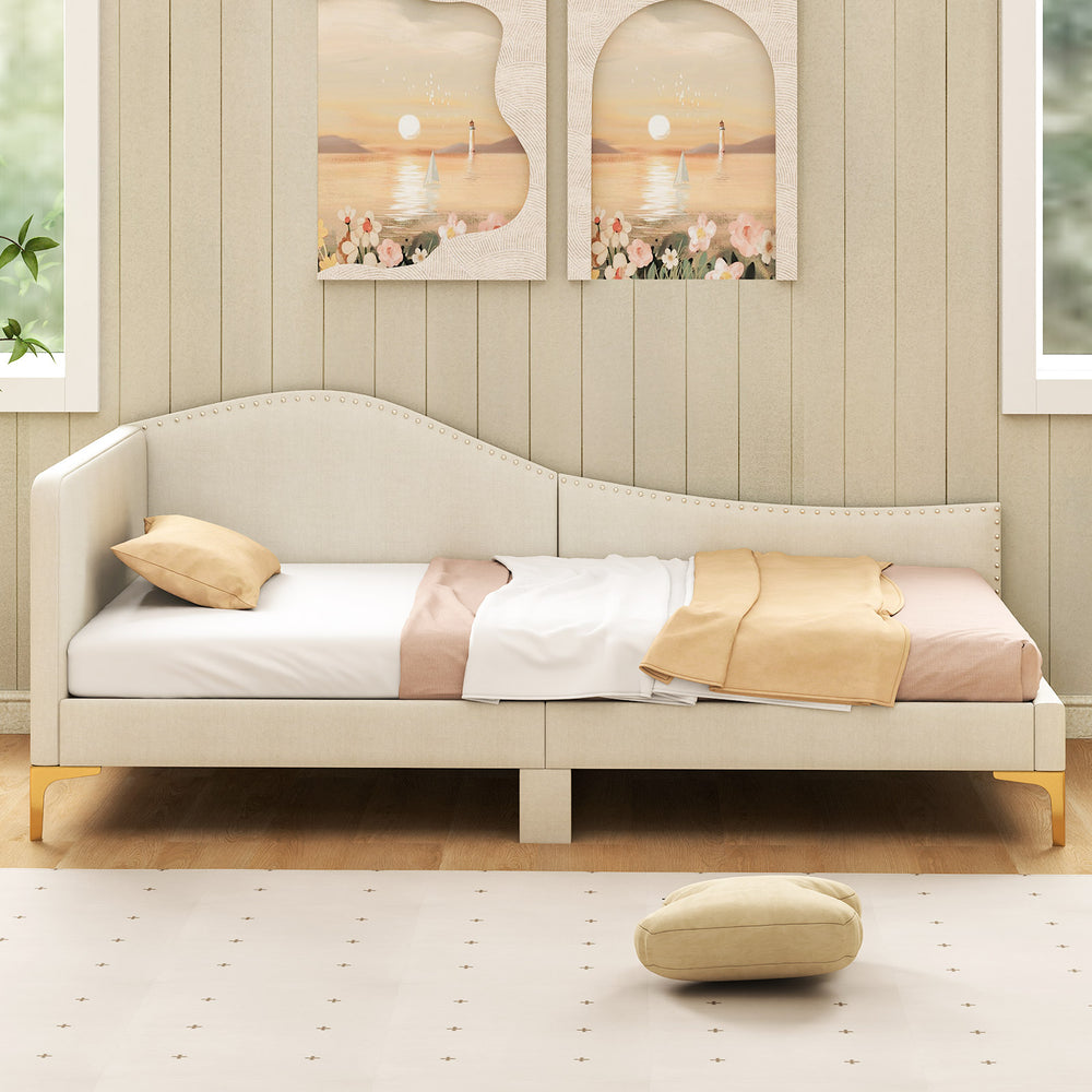 Upholstered twin size daybed with metal legs, featuring a rivet design and breathable linen fabric for versatile use.