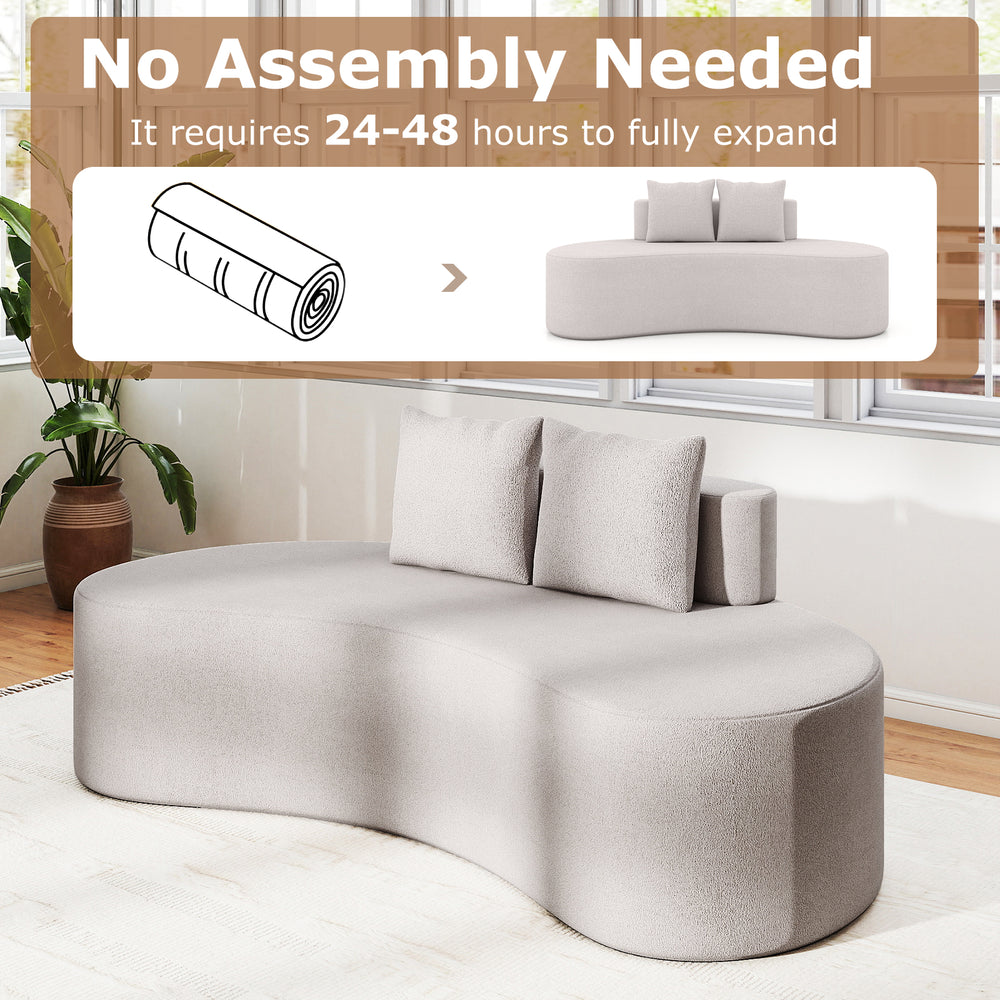 Curved upholstered sofa in gray with two cozy pillows, ideal for living rooms and apartments, no assembly needed.