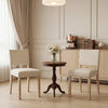 Upholstered dining chairs with solid rubber wood legs in beige, featuring ergonomic backrests for comfortable dining.