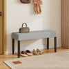 Upholstered gray entryway bench with padded seat and solid rubber wood legs, perfect for entryways or bedrooms.
