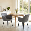 Gray upholstered PU leather kitchen chairs with curved back and wide seat, perfect for dining rooms and kitchens.
