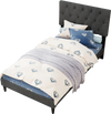 Tufted gray upholstered platform bed with wooden slats, featuring a soft padded surface and modern design for twin size.