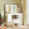 White vanity desk with lighted mirror, stool, ample storage, and built-in charging station for makeup application.
