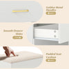 Close-up of the padded seat cushion and golden metal handle on the white vanity desk with ample storage and smooth.