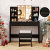 Black vanity set featuring a lighted mirror, cushioned stool, and ample storage with power outlet for convenience.