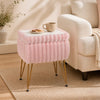Cozy pink vanity stool with plush upholstery and a reversible lid, ideal for use as a stylish end table or shoe bench.