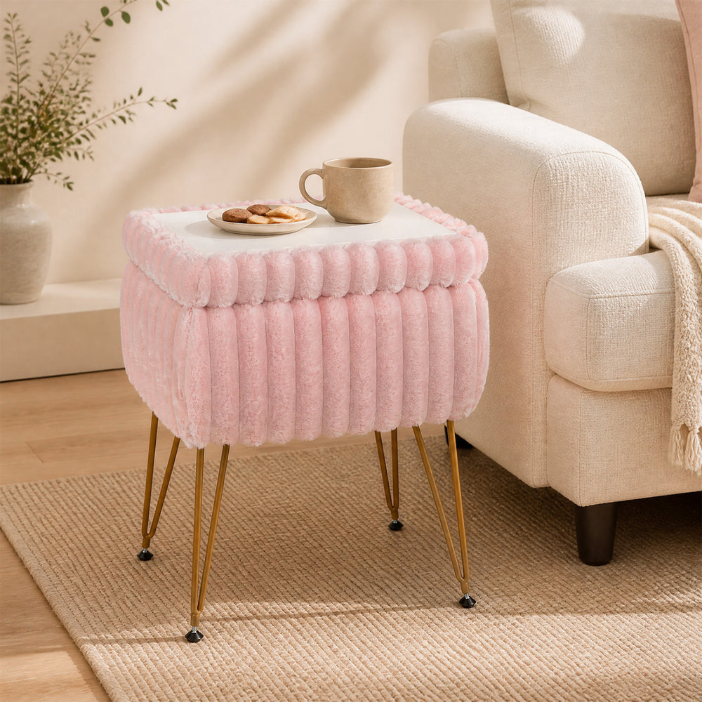 Cozy pink vanity stool with plush upholstery and a reversible lid, ideal for use as a stylish end table or shoe bench.