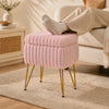 Plush pink vanity stool with storage and reversible lid, featuring sturdy metal legs, ideal for footrest or end table use.