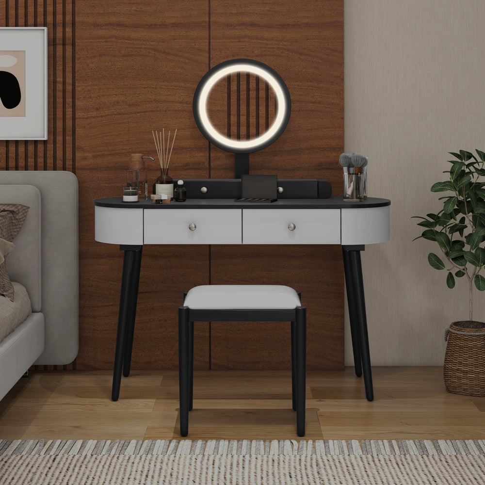 Makeup vanity table set in white and black with LED mirror, cushioned stool, and three spacious drawers for storage.