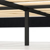 Close-up of the sturdy metal support leg and wooden slats of the velvet upholstered platform bed for enhanced stability.