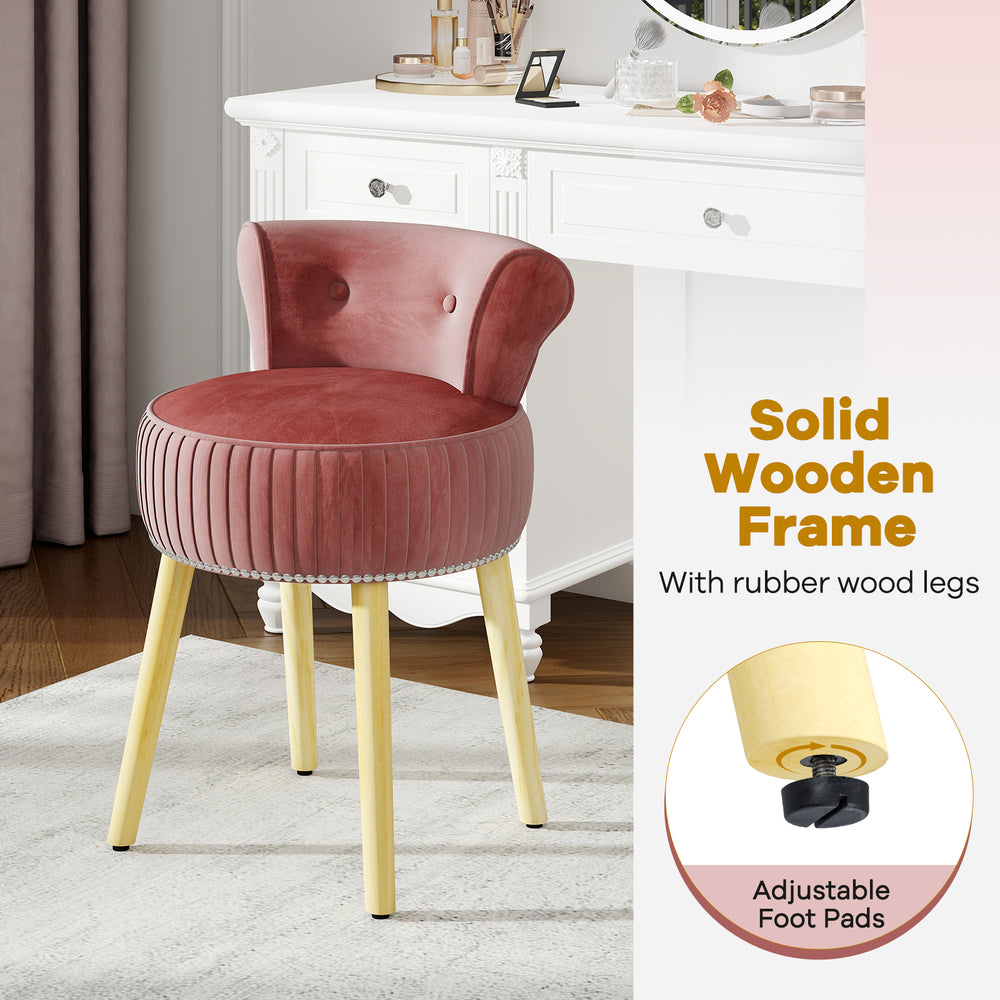 Velvet vanity chair in pink with tufted low back, solid wood legs, and adjustable foot pads for stability.