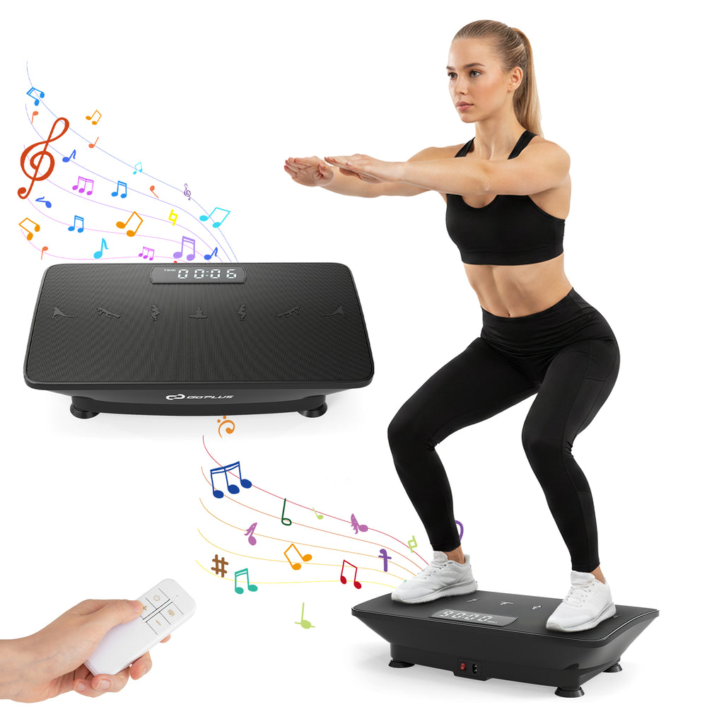Vibration plate exercise machine in black with remote, featuring a rubber surface and gravity sensor for home workouts.