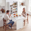 Wall-mounted fold-out convertible desk in white, featuring ample storage and a wide tabletop for versatile use.