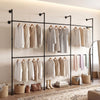Wall-mounted black clothing rack with 6 hanging rods, designed for organizing coats and dresses in small spaces.