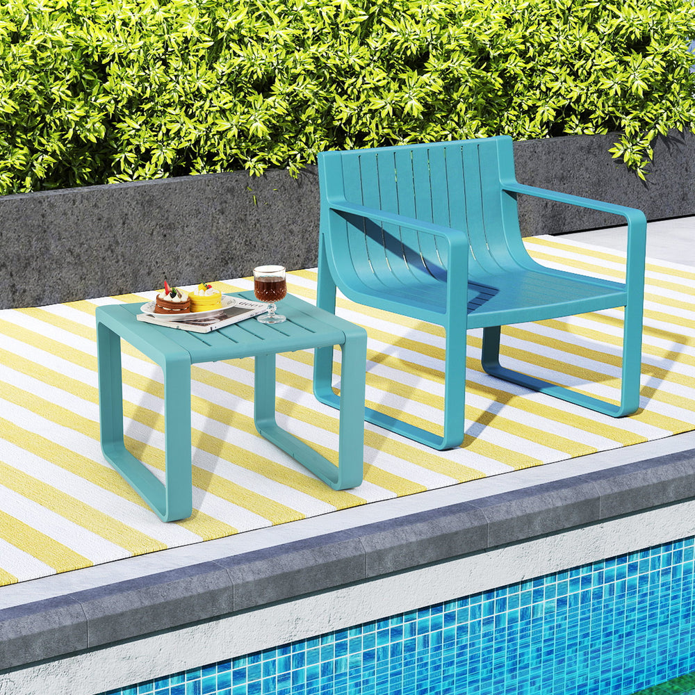 Blue weather-resistant Adirondack side table set by the poolside, featuring a classic slatted design and smooth.