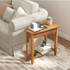 Narrow 2-tier end table in walnut with solid wood legs, perfect for small spaces in living rooms or bedrooms.