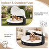 Wicker dog house with a soft, removable cushion and retractable canopy, designed for comfort indoors and outdoor shade.