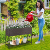 Wicker raised garden bed with storage shelf, featuring drainage gaps, ideal for growing flowers and herbs in the garden.