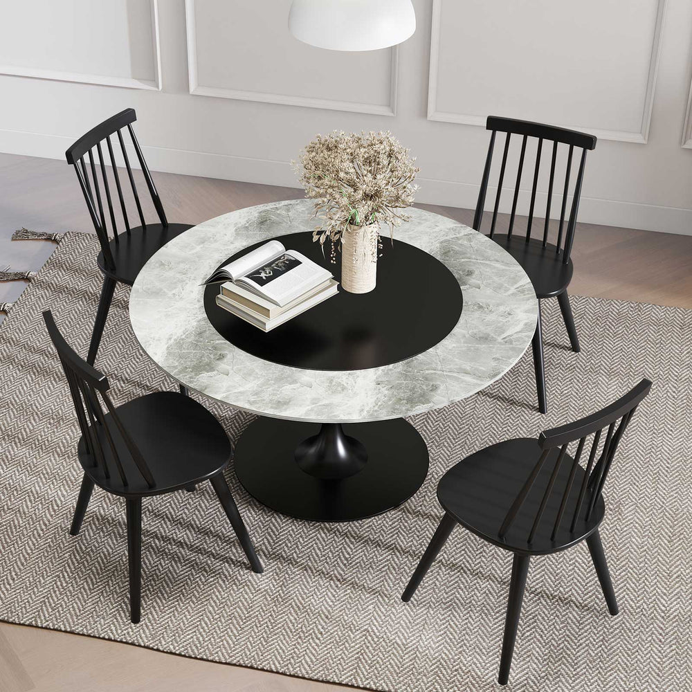 Round dining table with Windsor chairs in black, featuring a sleek design, ideal for modern dining rooms and cafes.