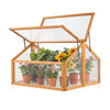 Wood cold frame greenhouse with a raised design and transparent panels, perfect for protecting flowers and extending.