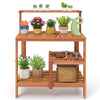Wooden outdoor garden potting workstation with open shelves, featuring plants and tools, ideal for patio and backyard.