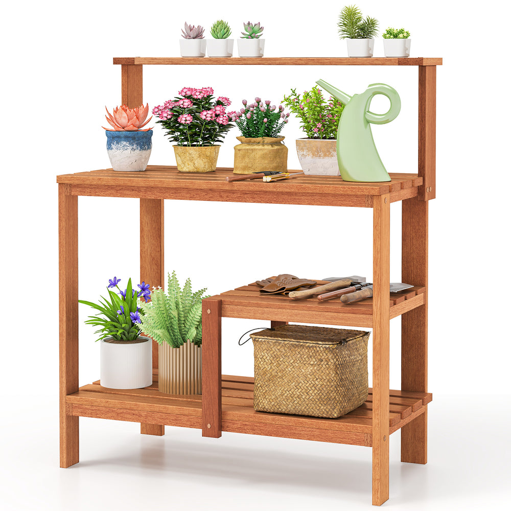 Wooden outdoor garden potting workstation with open shelves, featuring plants and tools, ideal for patios and backyards.