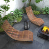 Two outdoor acacia wood rocking chairs with widened slatted seats, perfect for backyard relaxation and comfort.