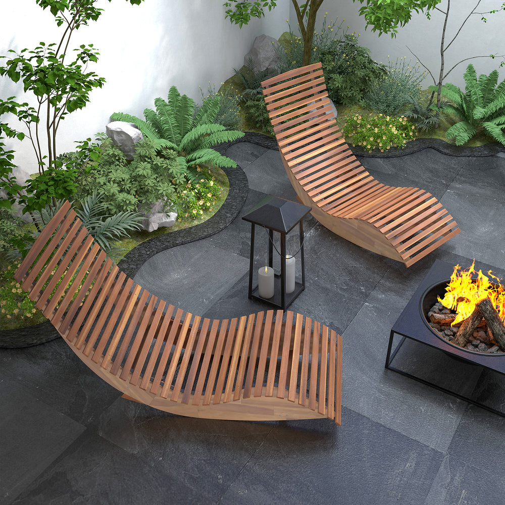 Two outdoor acacia wood rocking chairs with widened slatted seats, perfect for backyard relaxation and comfort.