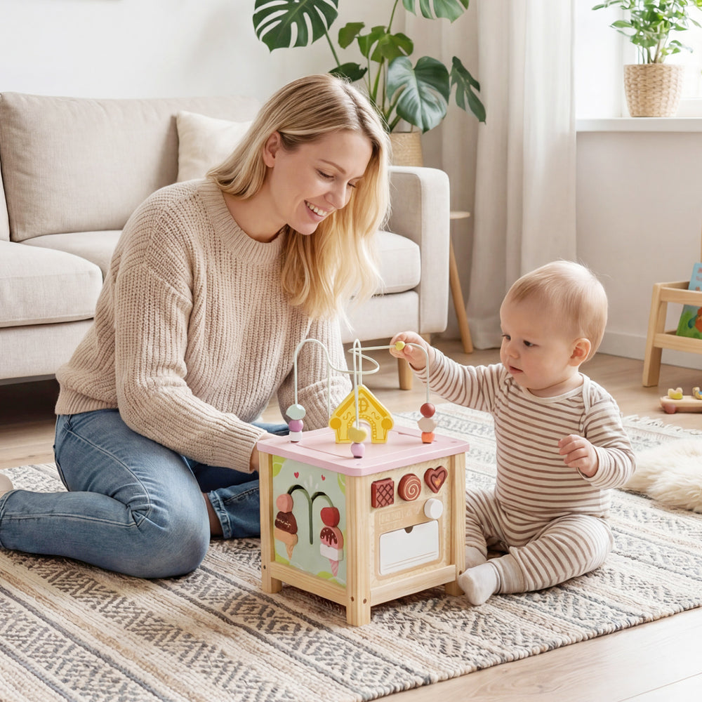 Wooden activity cube with sensory toys, featuring a dessert theme, for toddlers 18+ months, enhancing cognitive skills.