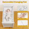 Removable waterproof changing pad on a wooden baby changing table with safety belt, ideal for secure diaper changes.