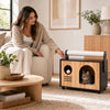 Wooden cat house with scratching post in black, featuring a removable cushion and playful design for interactive fun.